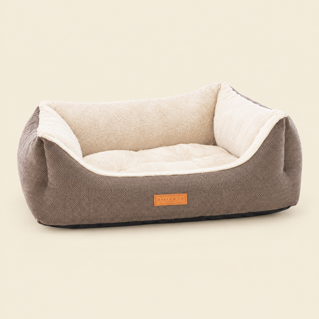 The Lincoln tweed bolster bed by Ralph & Co on a cream background