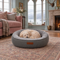 A Maltipoo asleep in the Balmoral herringbone calming donut bed by Ralph & Co, in a Perthshire castle drawing room