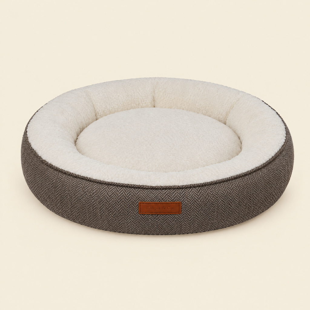 The Lincoln tweed calming donut bed by Ralph & Co on a cream background