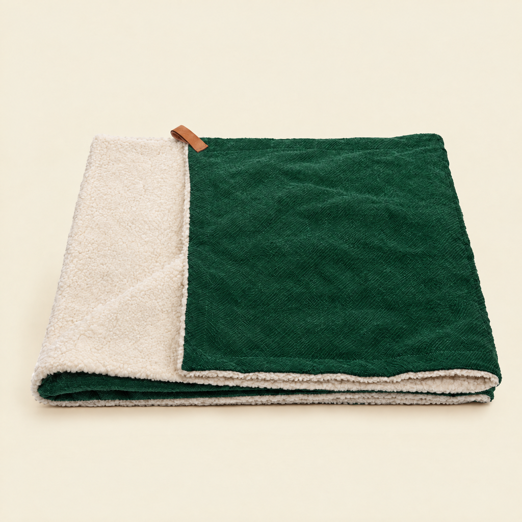 The Richmond Green Stonewashed & Sherpa Reversible Blanket by Ralph & Co, folded, on a cream background