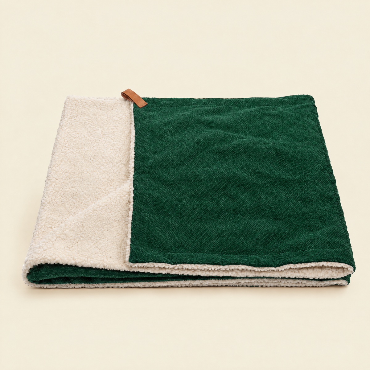 The Richmond Green Stonewashed & Sherpa Reversible Blanket by Ralph & Co, folded, on a cream background