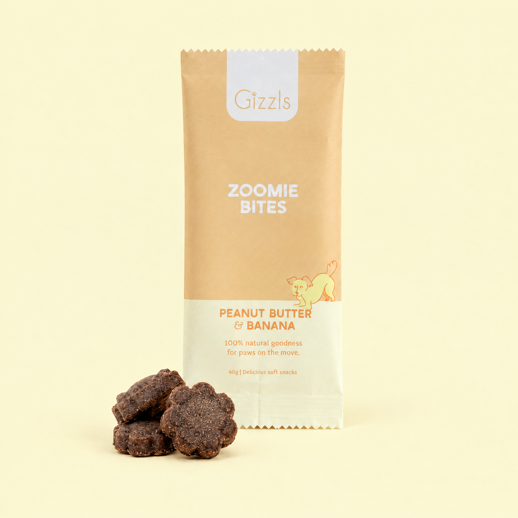 Gizzls Zoomie Bites Peanut Butter & Banana pack with treats on cream