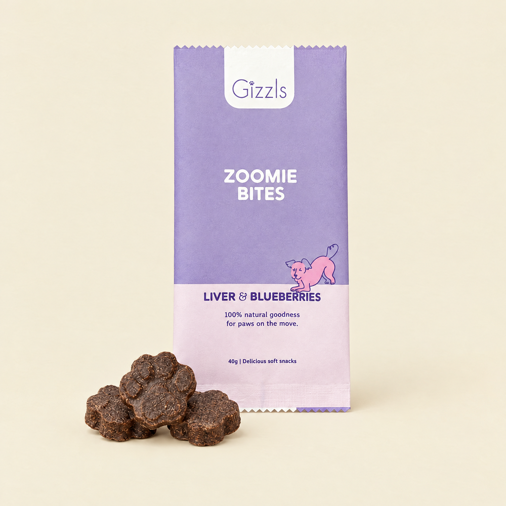 Gizzls Zoomie Bites Ostrich Liver & Blueberry pack with treats on cream