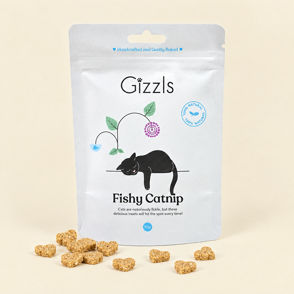 Gizzls Fishy Catnip Cat Treats pack with treats on cream