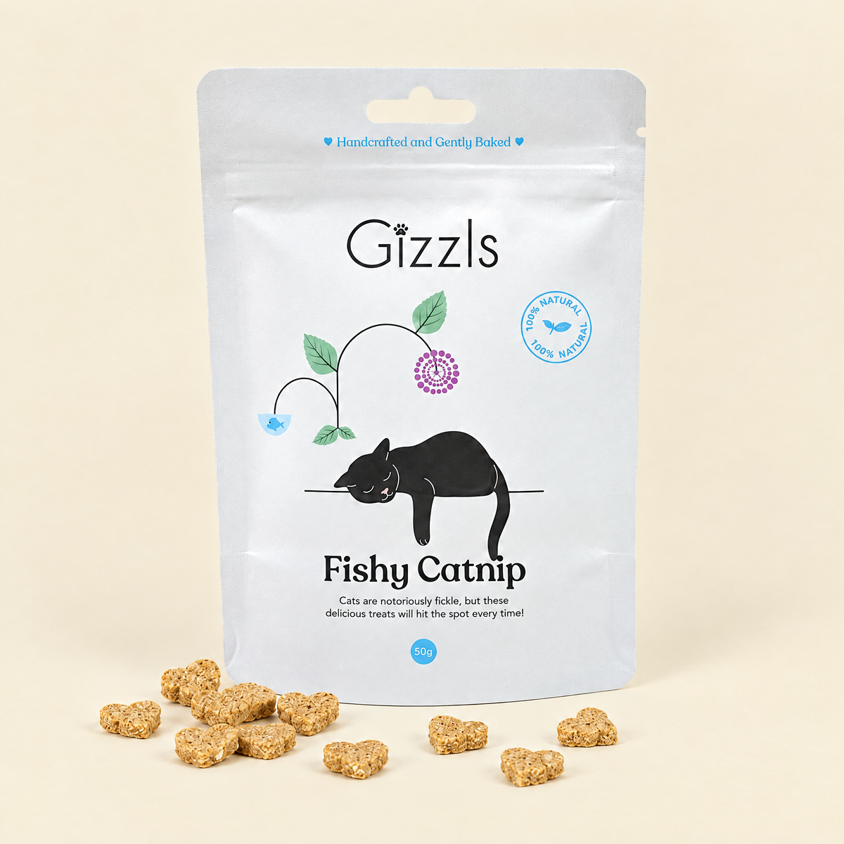 Gizzls Fishy Catnip Cat Treats pack with treats on cream