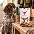 German Shorthaired Pointer gazing at a pack of Buffalo Trachea Rounds by The Buffalo Co.