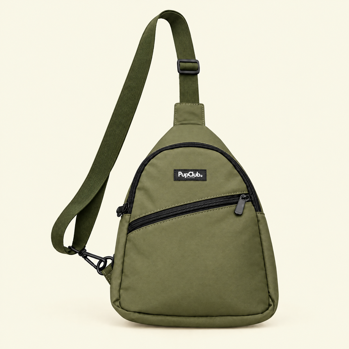 Khaki green dog walking sling bag on a plain cream background