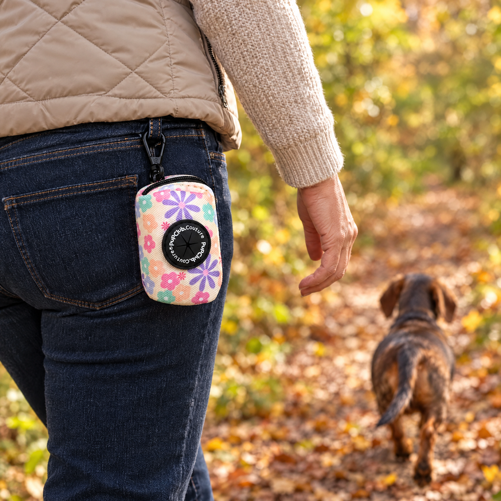 Pretty Petals poo bag holder clipped to a belt on a dog walk