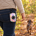 Pretty Petals poo bag holder clipped to a belt on a dog walk