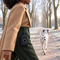 Midnight Black poo bag holder clipped to a belt on a dog walk