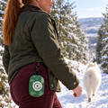 Evergreen Trails poo bag holder clipped to a belt on a dog walk
