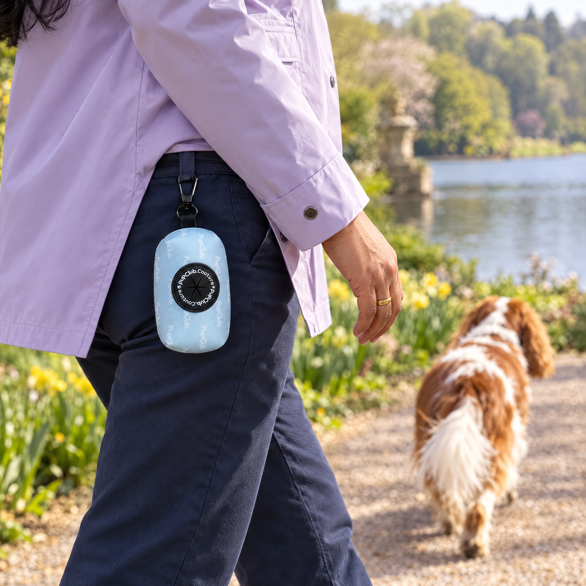 Pastel Blue poo bag holder clipped to a belt on a dog walk