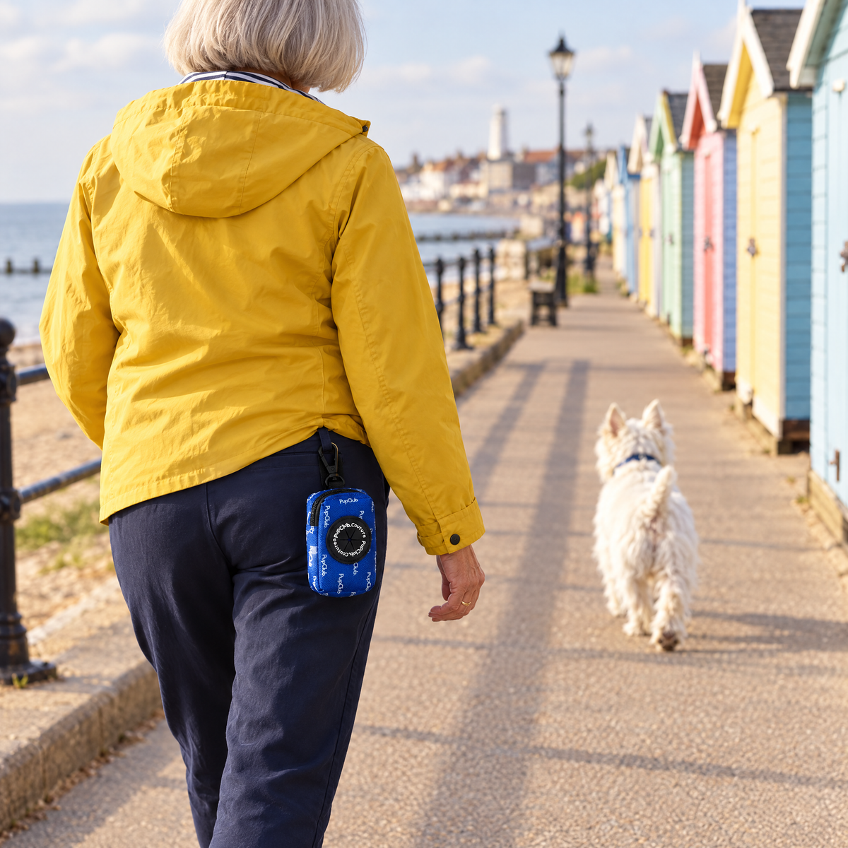 Royal Blue poo bag holder clipped to a belt on a dog walk