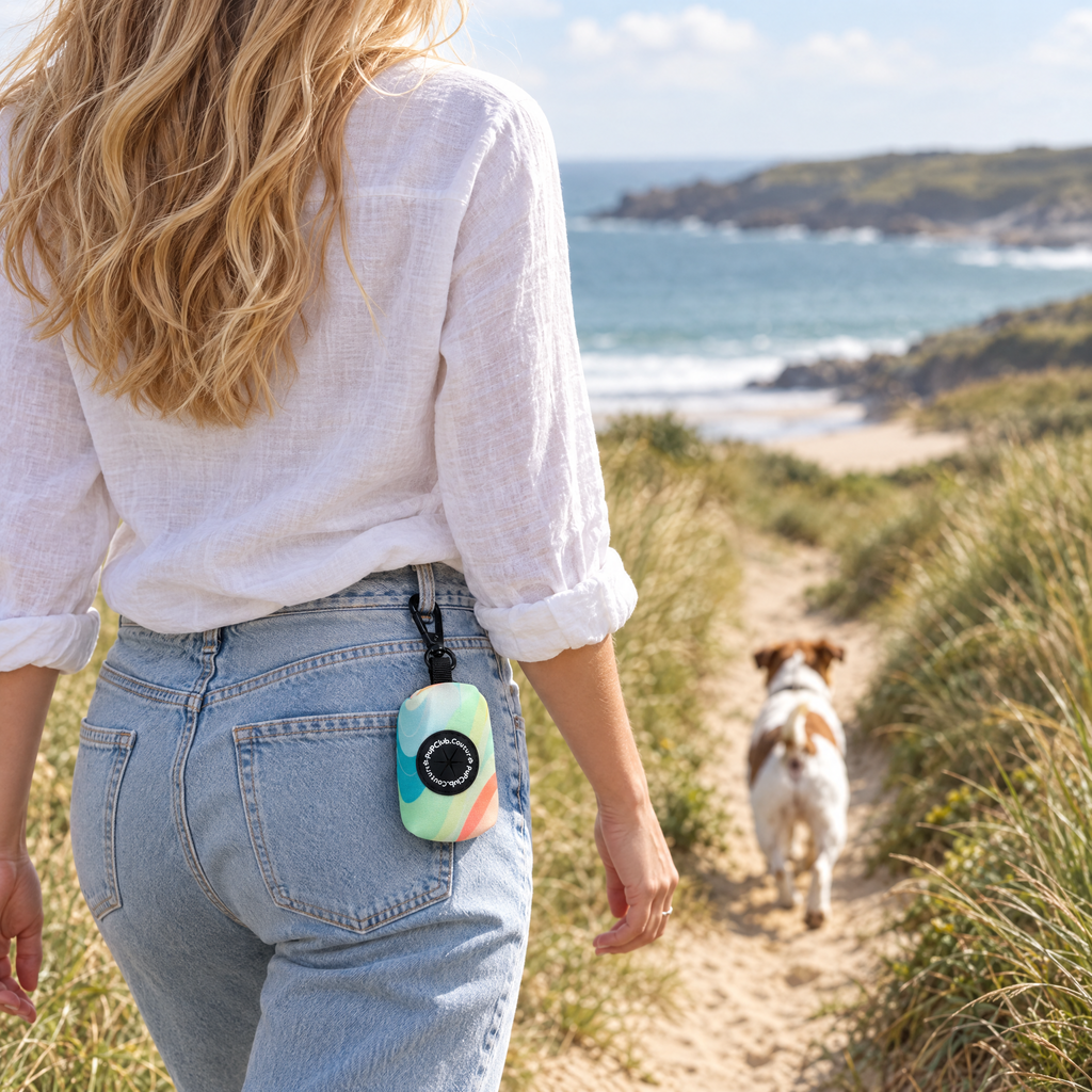 Pastel Waves poo bag holder clipped to a belt on a dog walk