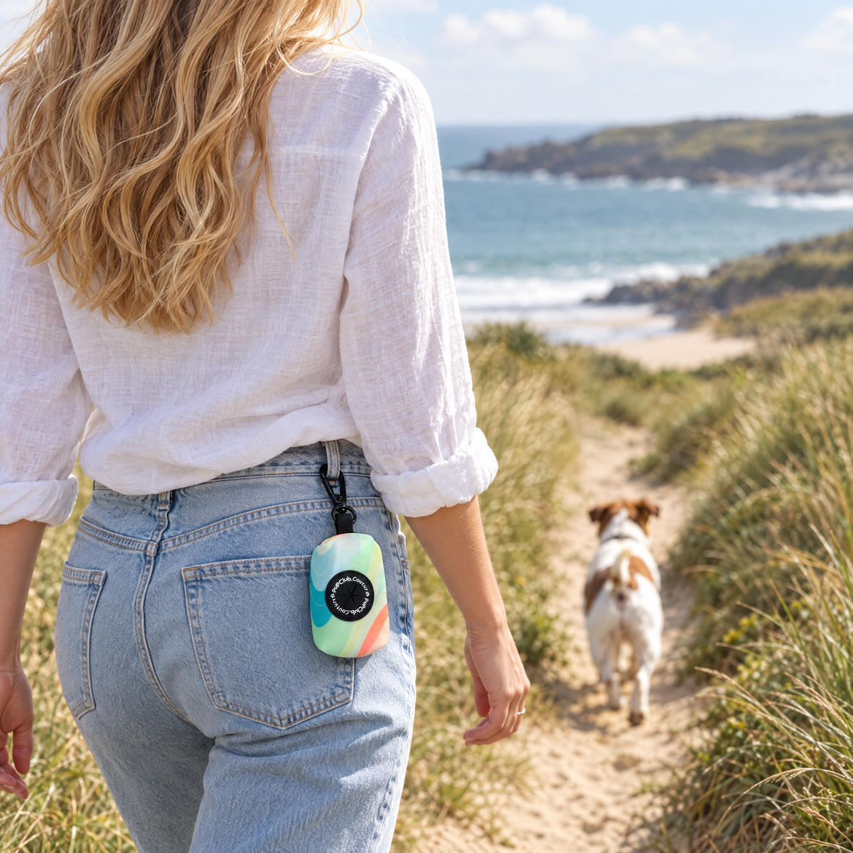 Pastel Waves poo bag holder clipped to a belt on a dog walk