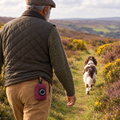 Berry Tweed poo bag holder clipped to a belt on a dog walk