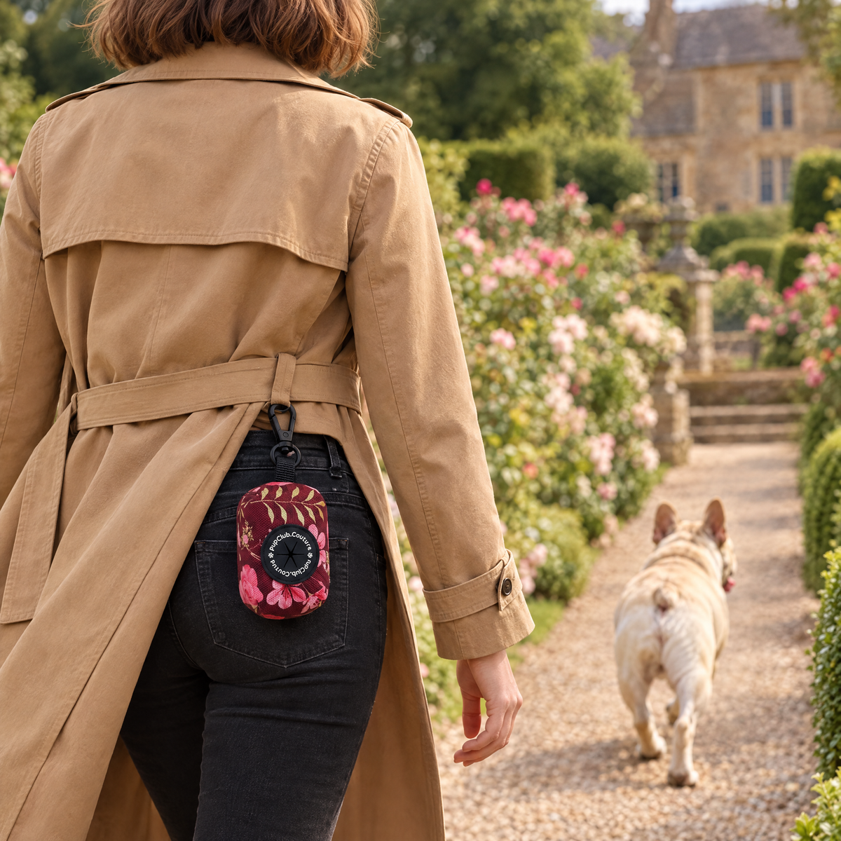 Burgundy Bloom poo bag holder clipped to a belt on a dog walk