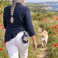 Summer Meadow poo bag holder clipped to a belt on a dog walk