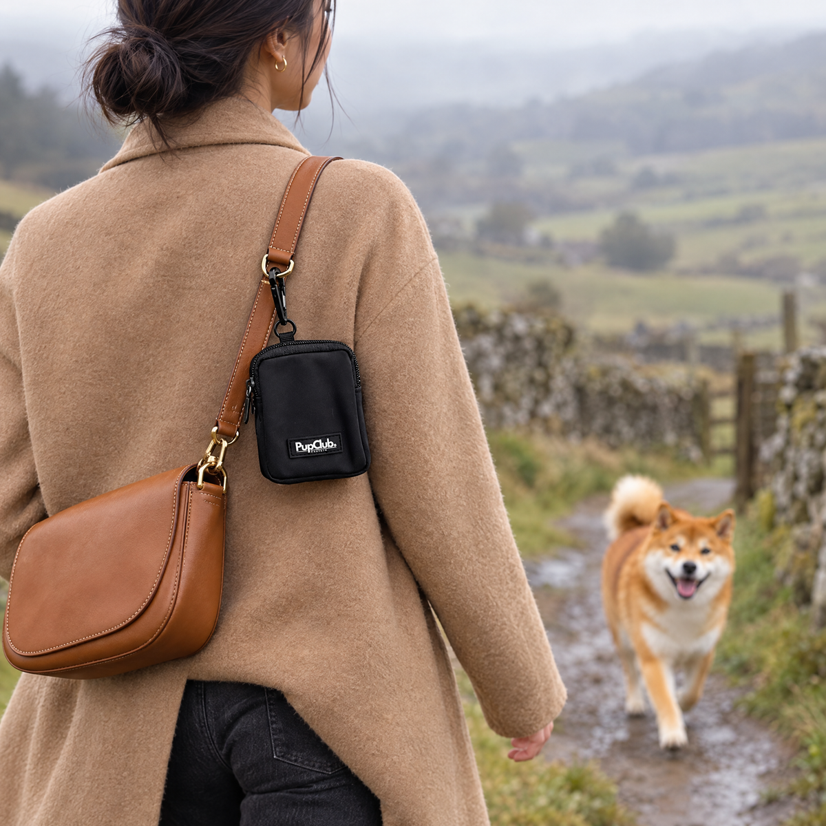 Black treat pouch clipped on for a dog walk