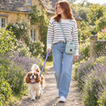 Dog walker wearing the Sage Green mini dog walking bag by PupClub Couture