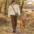 Dog walker wearing the Khaki Green mini dog walking bag by PupClub Couture