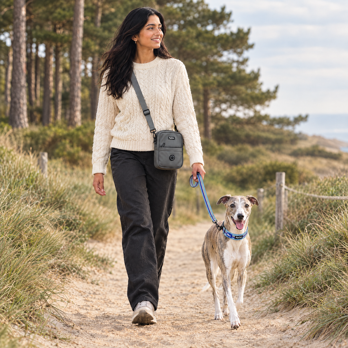 Dog walker wearing the Grey mini dog walking bag by PupClub Couture